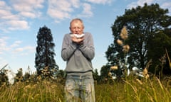 Man sneezing in tall grass