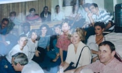 A photo of various crew members sitting on the floor of a room in a hotel