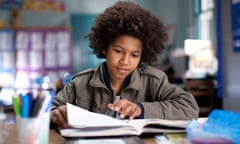 Boy reading in classroom.