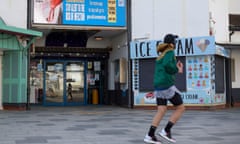 A jogger passes a coronavirus information sign in Bournemouth, Dorset