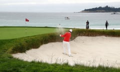 Justin Rose plays a shot from a bunker