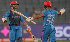 Azmatullah Omarzai (left) celebrates after reaching his half-century for Afghanistan