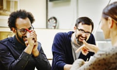 Laughing architects at conference table in office