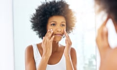 This protects my skin the entire day<br>Posed by model
Cropped shot of an attractive young woman applying moisturizer on her face in the bathroom at home