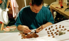 Young man counting coins on a bed