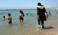 A woman wearing a burkini paddles on the seashore in Marseille, southern France. Photograph: AP