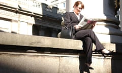 Businesswoman reading the newspaper