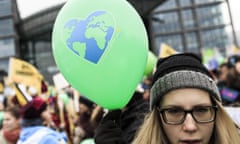 A woman holds a balloon as activists participate in the Global Climate March  in Berlin, Germany.