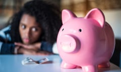 Sad frustrated black woman with piggy bank