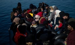 Migrants, who crossed part of the Aegean Sea from Turkey, are seen on a dinghy with a damaged engine, as locals prevent them from docking.