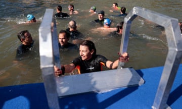 Paris mayor Anne Hidalgo gets up after swimming in the river Seine