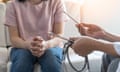 Female patient consulting with doctor holding stethoscope