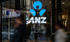People are seen walking past an ANZ branch in Melbourne, Australia