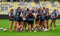 NSW Blues players huddle during a Women's State of Origin captain's run at Queensland Country Bank Stadium