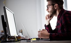 A man looking at a computer