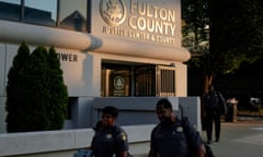 police officers walk past a courthouse