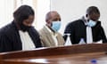 Paul Rusesabagina sits with his lawyers inside the  court in Kigali, Rwanda.