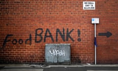 A sign painted on the side of a house directs people to a local food bank in Leeds, England.