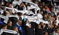 Leicester supporters holding commemorative scarves