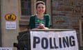 Carla Denyer smiles as she stands next to a polling station sign