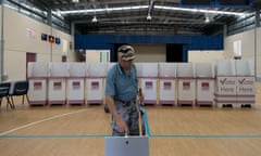 A voter casts his ballot after voting in the 2015 Queensland state election.