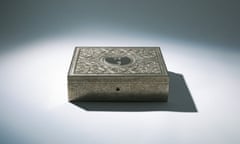 A silver box with intricate designs and Wu-Tang Clan's logo