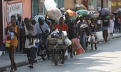 People flee their homes in Port-au-Prince as police confront armed gangs.