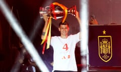 Álvaro Morata carries the European Championship trophy on to the stage at Spain’s victory rally in Madrid.