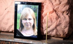 Picture of  Kateryna Handzyuk with a candle next to it at rally.