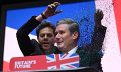 A protester throws glitter over Keir Starmer