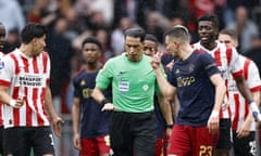 Players speak to referee Serdar Gozubuyuk during the match between PSV Eindhoven and Ajax.