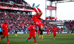 Canada's Tajon Buchanan flips upside down in celebration after scoring against Jamaica