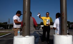 Alejandro Zuniga of the Fe y Justicia Worker Center offers water and literature to day laborers in Houston, where the Hurricane Harvey recovery has been marred by abuses of workers’ rights.