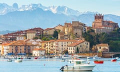 panoramic views to san vicente de la barquera traditional village at cantabria, spain<br>san Vicente de la barquera Spanish town with mountain range at background