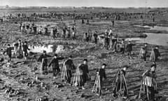 Communist China - teachers from Qinghua (Tsinghua) University and Beijing University forced to do heavy manual work during the Cultural Revolution period.  They are carrying stones to reinforce a dyke, in order to prevent flooding.