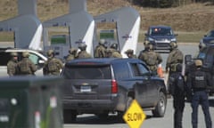 Royal Canadian Mounted Police officers prepare to take a person into custody at a gas station in Enfield, Nova Scotia on 19 April 2020.