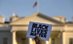 FILE - In this July 8, 2016 file photo, a man holds up a sign saying "black lives matter" during a protest of shootings by police, at the White House in Washington. Black social media users are nearly twice as likely to see posts about race and race relations as whites, according to a report released Monday, Aug. 15, 2016, by the Pew Research Center.  (AP Photo/Jacquelyn Martin)