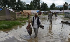 Nepalese earthquake victims collect belongings from a temporary shelter after the Hanumente River overflowed following monsoon rain in Bhaktapur on the outskirts of Kathmandu on August 27, 2015. Monsoon rains are slowing rebuilding and relief efforts after nearly 8,900 people died and some 600,000 homes were reduced to rubble across the impverished Himalayan nation following the deastating earthquake that struck Nepal on April 25. AFP PHOTO / Prakash MATHEMAPRAKASH MATHEMA/AFP/Getty Images