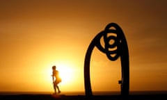 A woman exercises next to the memorial at Coogee beach dedicated to the victims of the Bali bombings