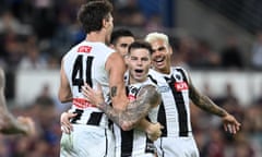 Collingwood’s Jamie Elliott (centre) celebrates kicking a goal during the AFL grand final rematch against Brisbane at the Gabba.