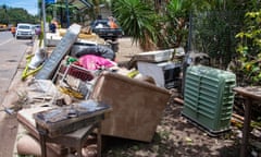 Flood-damaged furniture and belongings on the street in Machans Beach in Cairns