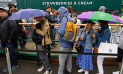 Visitors to Wimbledon queue up for strawberries and cream at the Championships
