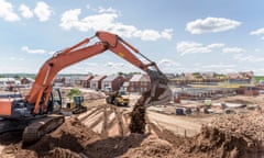 Excavator moving earth on housing building site