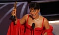 Ariana DeBose accepts the Oscar for best supporting actress.