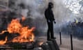 A protester next to a burning barricade in Paris