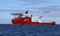 An RAAF Orion flying past a large research ship