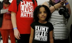 FILE PHOTO: File photo of Flint Michigan residents waiting in line for a House Oversight and government Reform hearing on Capitol Hill in Washington<br>FILE PHOTO: Mari Copeny, 8, of Flint, Michigan, waits in line to enter a hearing room where Michigan Governor Rick Snyder (R) and EPA Administrator Gina McCarthy will testify before a House Oversight and government Reform hearing on "Examining Federal Administration of the Safe Drinking Water Act in Flint, Michigan, Part III" on Capitol Hill in Washington in this March 17, 2016, file photo. Beyond the liability protection enjoyed by government officials, Flint residents who have filed lawsuits over the contaminated water may face challenges in demonstrating that it caused any particular injuries, lawyers and legal experts say. REUTERS/Kevin Lamarque/Files/File Photo