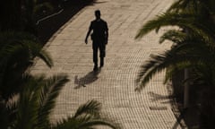 A police officer patrols in the grounds of the H10 Costa Adeje Palace hotel in La Caleta, in the Canary Island of Tenerife, Spain, Wednesday, Feb. 26, 2020. Spanish officials say a tourist hotel in Tenerife has been placed in quarantine after an Italian doctor staying there tested positive for the COVID-19 virus and Spanish news media says some 1,000 tourists staying at the complex are not allowed to leave. (AP Photo)