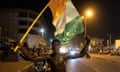 An Ivory Coast supporter celebrates Monday’s victory over Senegal on a street in the northern city of Korhogo