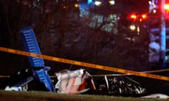 debris from a plane behind police tape at night